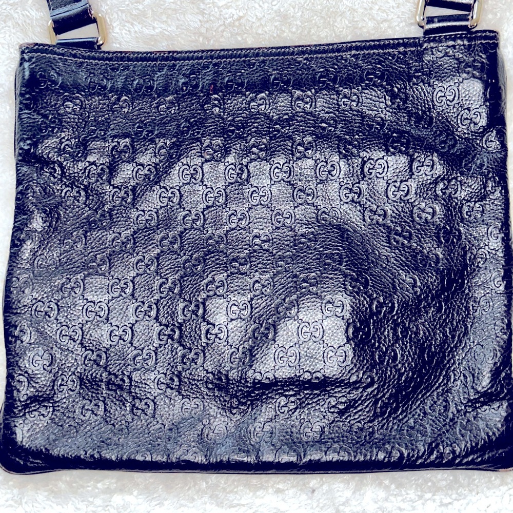I am selling a dark brown Gucci leather sling/messenger bag.